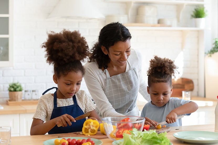 Mom teaching two girls to cook